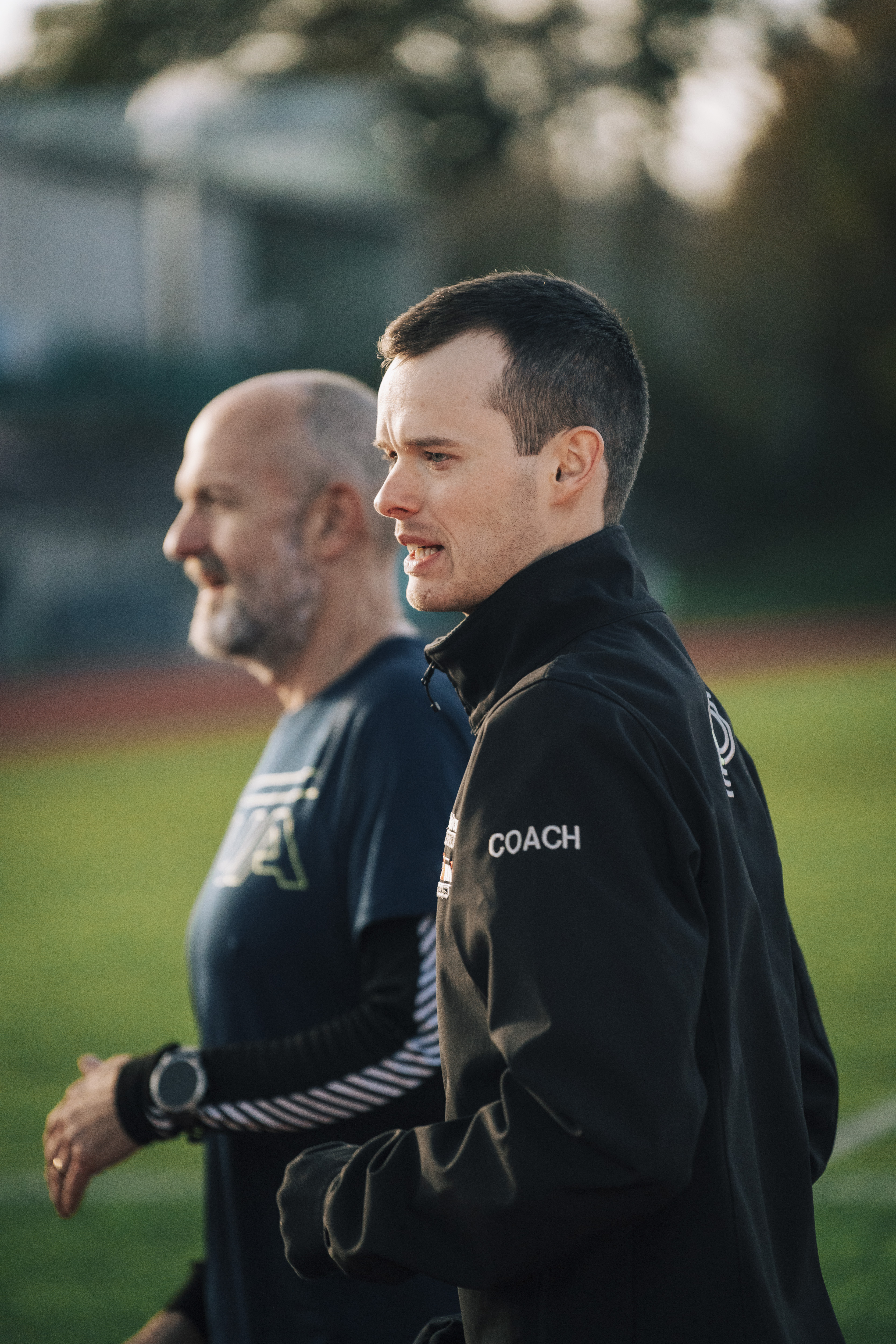 A triathlete running outdoors during a focused training session.
